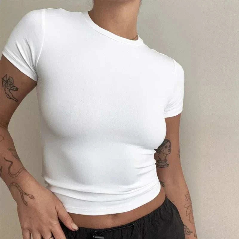 Model wearing a white fitted tee from the womens trendy apparel collection, showcasing casual style and comfort.