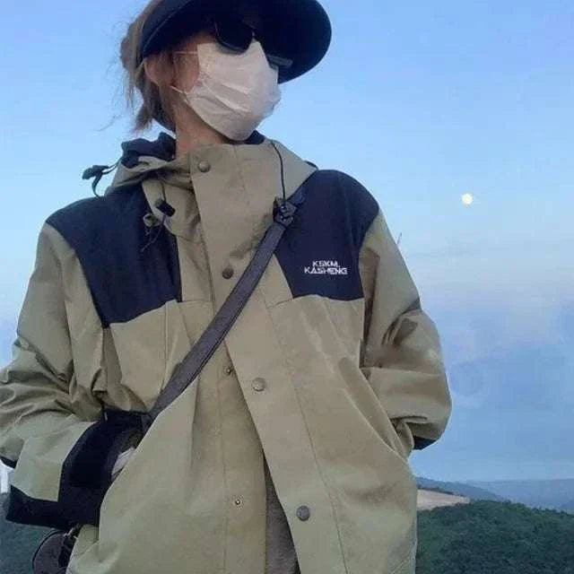 Person wearing retro charging clothes jacket in beige and black outdoors with mask and cap