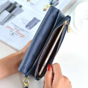 blue PU leather women's long wallet with zipper and compartments holding a smartphone