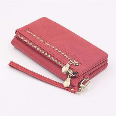 Pink women's long wallet made of PU leather with zipper closure and multiple compartments