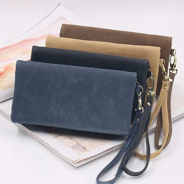 Set of women's long wallets in navy blue, black, beige, and brown faux leather with zipper closure and wrist strap.