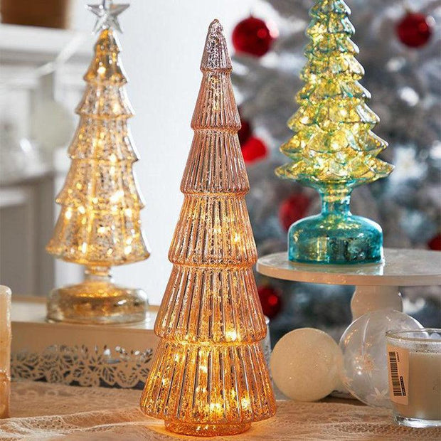 Glass geometric Christmas tree table decorations with LED lights in gold, pink, and green colors for festive scenes