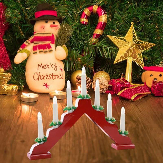 Wooden Christmas window decorations with red and white candlesticks and festive background elements