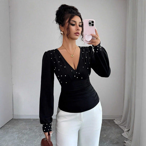 Women’s black V-neck pearl embellished fitted long sleeve top with bell sleeves