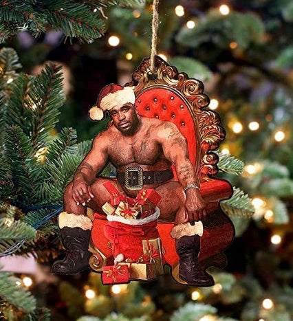 Christmas Wooden Pendant featuring a muscular man in Santa outfit sitting on a red ornate throne with gifts, hanging on a Christmas tree branch