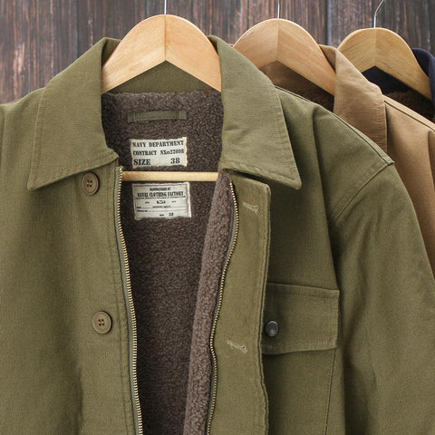 Men padded work clothes thickened cotton jacket with velvet lining in khaki, army green, and brown colors on wooden hangers