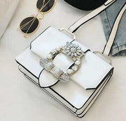White fashion designer bag with diamond lock and pearl embellishments