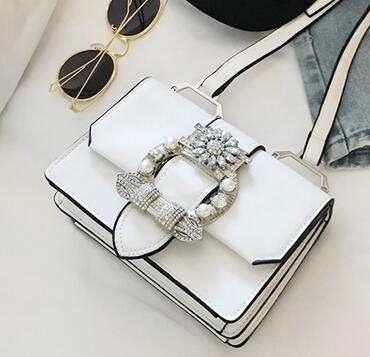 White fashion designer bag with diamond lock and pearl embellishments