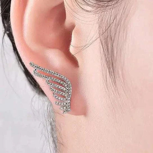 Angel Wings Fine Earrings – Elevate Your Style, showcasing a sparkling wing design on the ear.