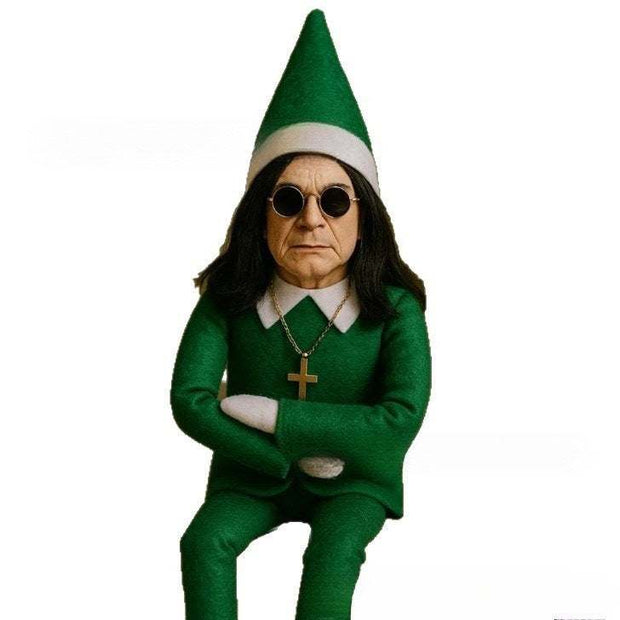 Christmas Oz Doll in green elf costume with sunglasses and cross necklace sitting with arms crossed