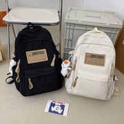 Solid multi-pocket backpack for juniors, black and white nylon schoolbags with large capacity and pendant charm.