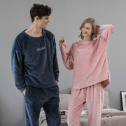 Couple wearing flannel winter home clothes in navy and pink cozy sleepwear sets