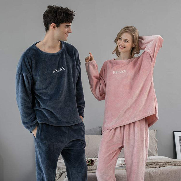 Couple wearing flannel winter home clothes in navy and pink cozy sleepwear sets
