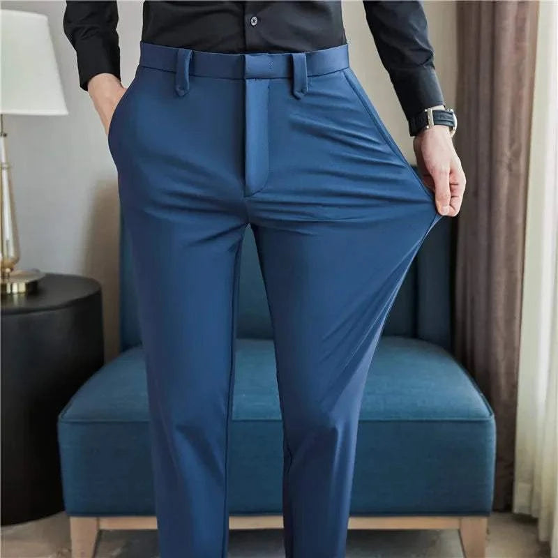 Mens dress pants showing stretchable slim fit design in blue color worn with black shirt