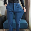 Mens dress pants showing stretchable slim fit design in blue color worn with black shirt