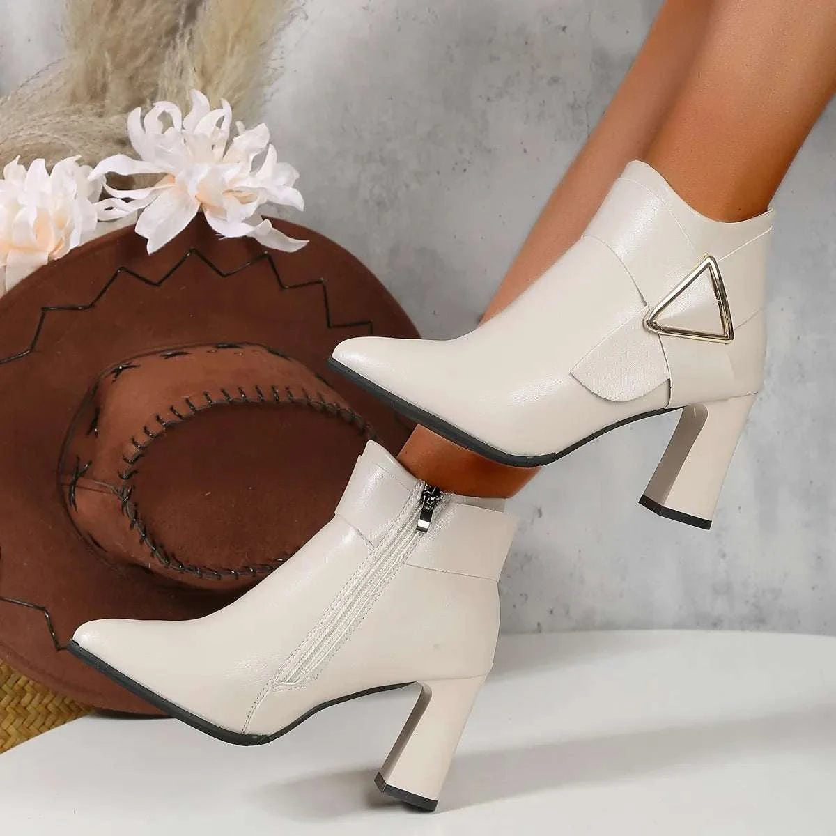 White heeled short ankle boots for women with pointed toe and side buckle detail