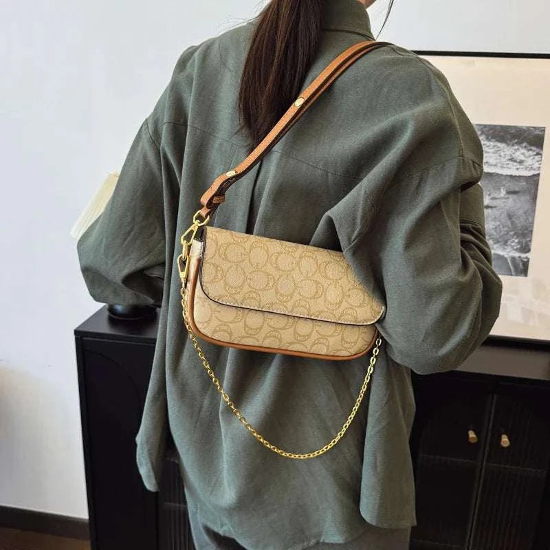 Vintage fashionable tote bag with large capacity and zipper closure worn on shoulder