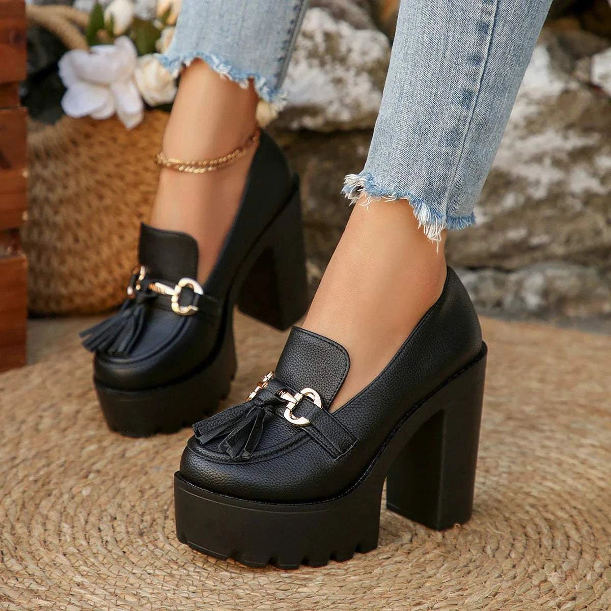 Black platform high heels women shoes with chunky heel and tassel detail worn with frayed jeans