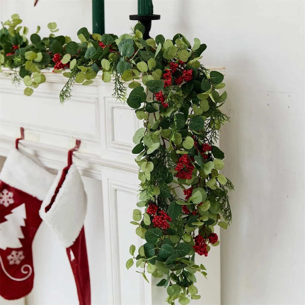 6.3ft artificial Christmas decoration garland with green leaves and red berries on mantelpiece