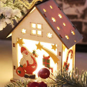 Wooden Christmas house decoration with LED lights and Santa motif illuminating warm glow
