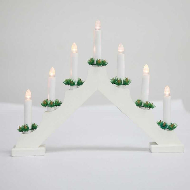 White wooden Christmas window decoration candlesticks with LED lights and green accents