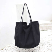 Large black canvas women handbag with high capacity and shoulder straps for shopping and daily use