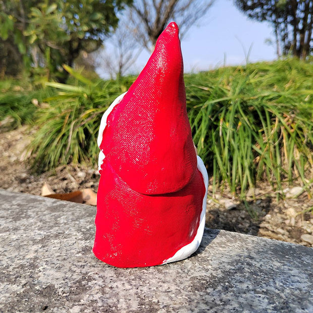 Red Santa statue garden Christmas decoration made of synthetic resin outdoors