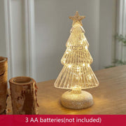 Glittered geometric Christmas tree table decoration with warm lights on wooden surface