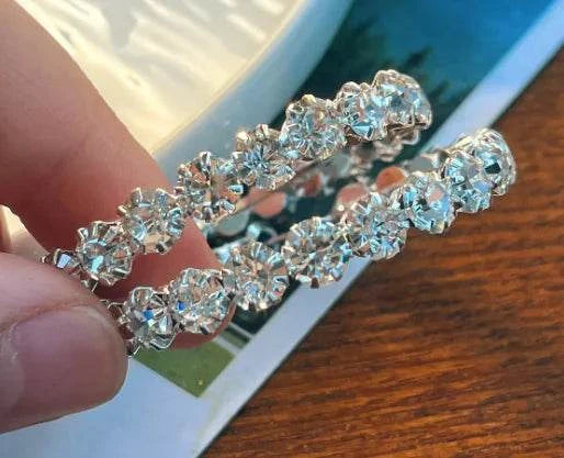 Crystal Earrings - Versatile Stud Earrings held in hand, showcasing stunning geometric design and sparkling artificial crystals.