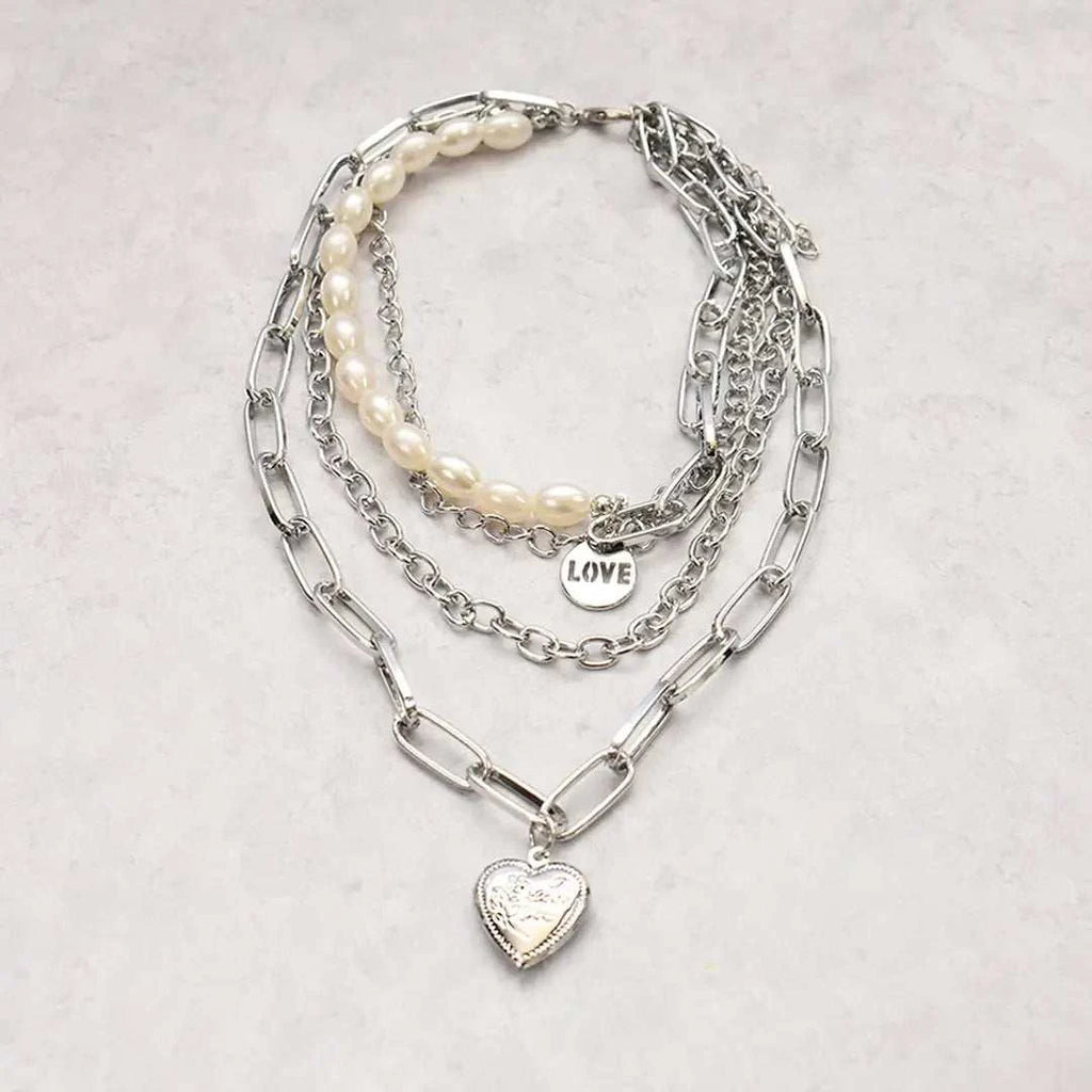 Jester Necklace - Dazzling Chain with Pearls & Heart featuring silver chains and a heart pendant.