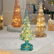 Glittered geometric glass Christmas tree table decorations with warm lights for festive scenes