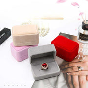 Velours flannelette jewelry box in multiple colors with heart-shaped ring inside and decorative background