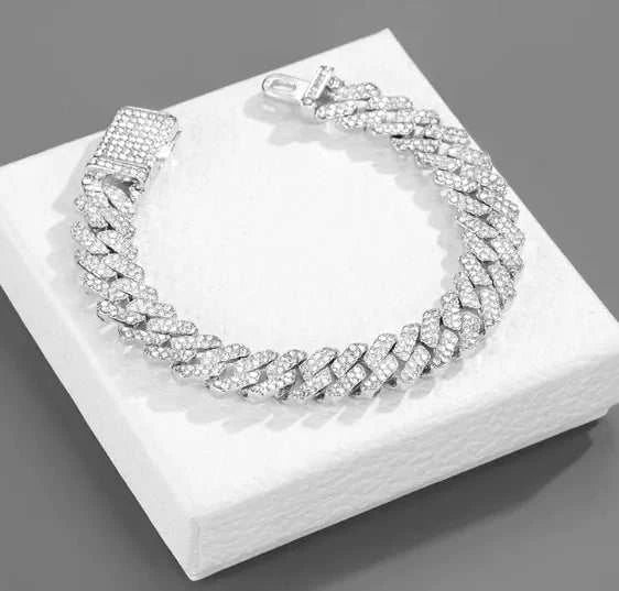 Necklace - Dazzling diamond-encrusted hip-hop jewelry on a display.
