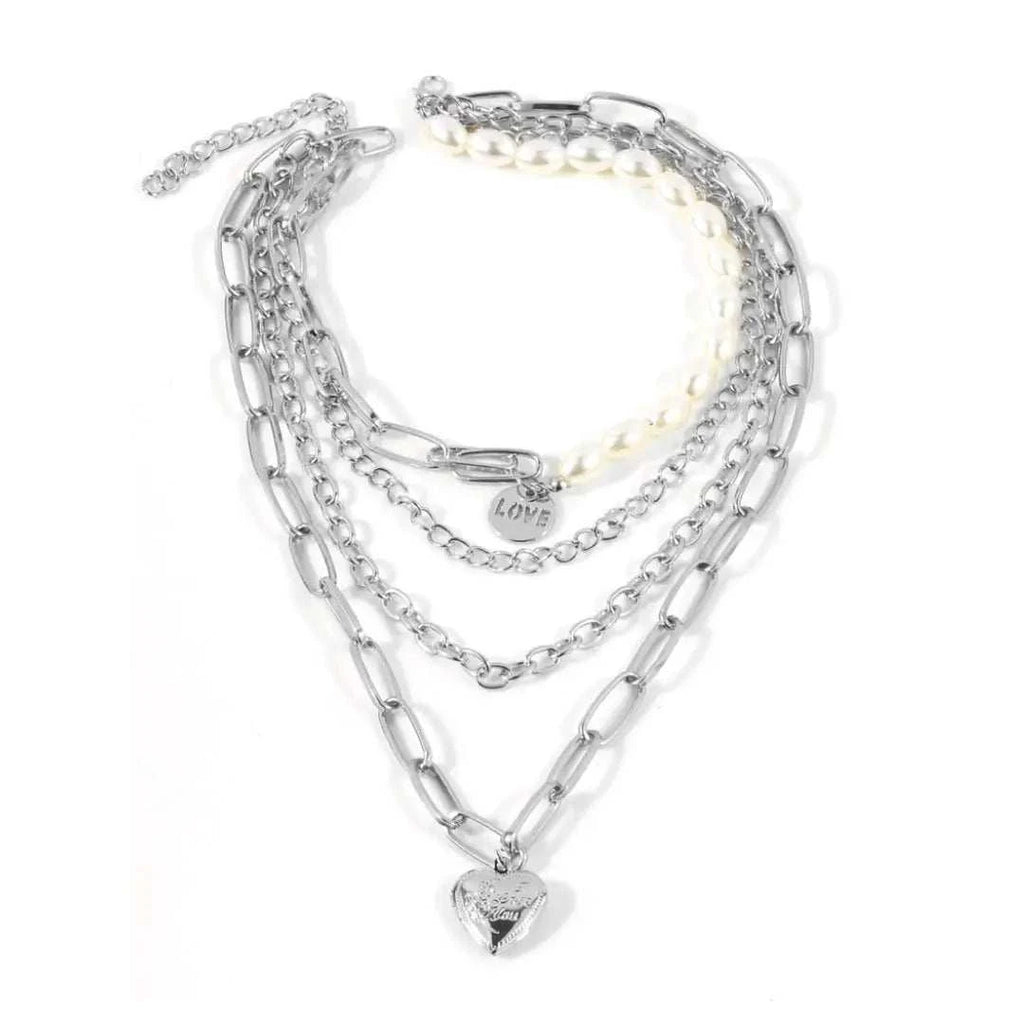 Jester Necklace featuring layered chains, pearls, and a heart pendant with a lobster claw closure.