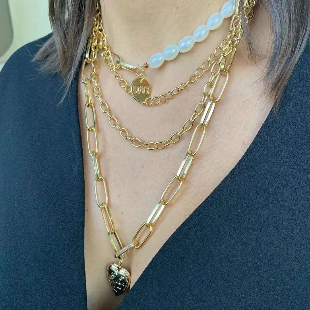 Jester Necklace - Dazzling Chain with Pearls & Heart showcasing a layered gold design with heart and love details.