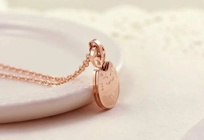 Totoro Necklace-Wealth Necklace-Rose Gold Titanium Steel displayed on a plate, showcasing its elegant design and craftsmanship.